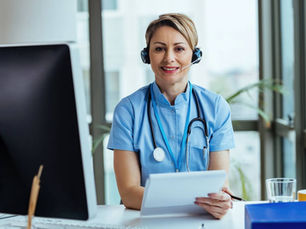 A healthcare professional answers a call at a medical answering services call center.