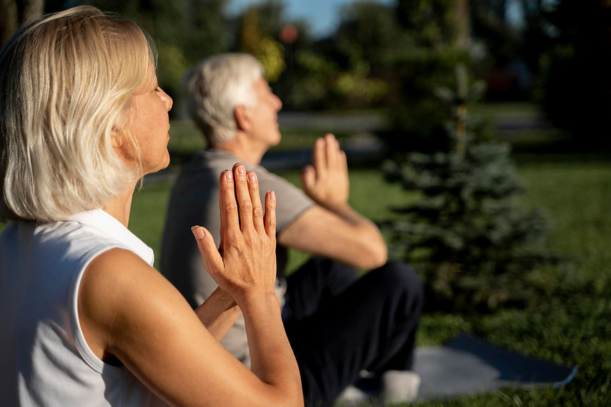 side-view-older-couple-practicing-yoga-outdoors.jpg