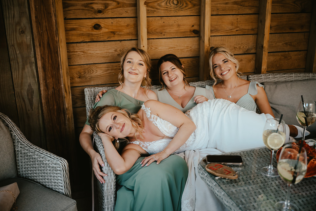 bride laying on bridesmaids lap