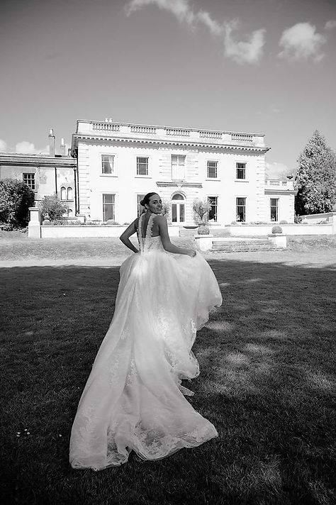 AJ Feather Photography at The Location House Bride running away from me to the house looki