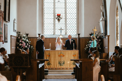 bride-groom-lighting-the-candle-at-the-front-of-the-church