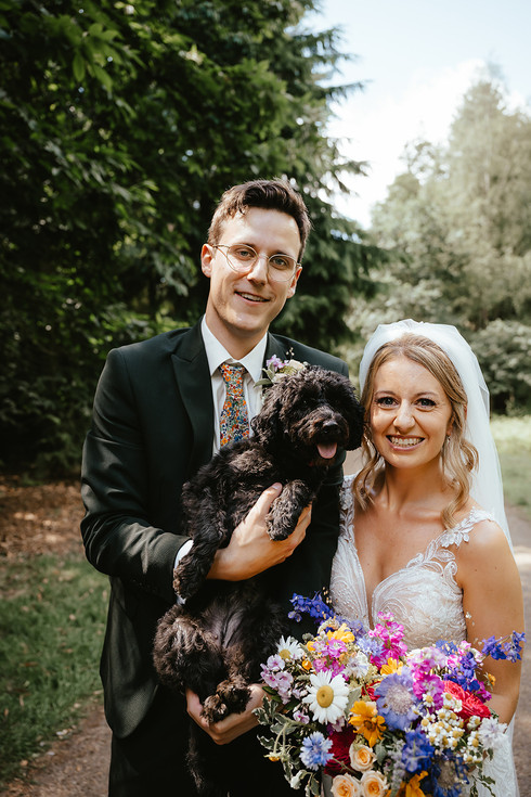 groom picks dog up and the all snuggle in close