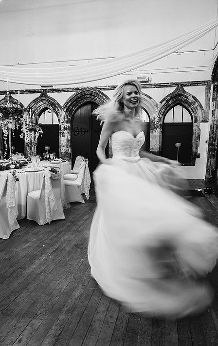 Styles shoot at The Priory Bride spinning in the wedding breakfast room with blury motion 