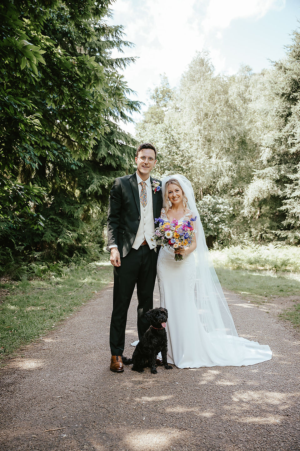 bride and groom and doggy tood having a a family portrait