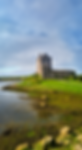 Dunguaire Castle overlooking the bay in Galway, Ireland, with stone walls and a central tower