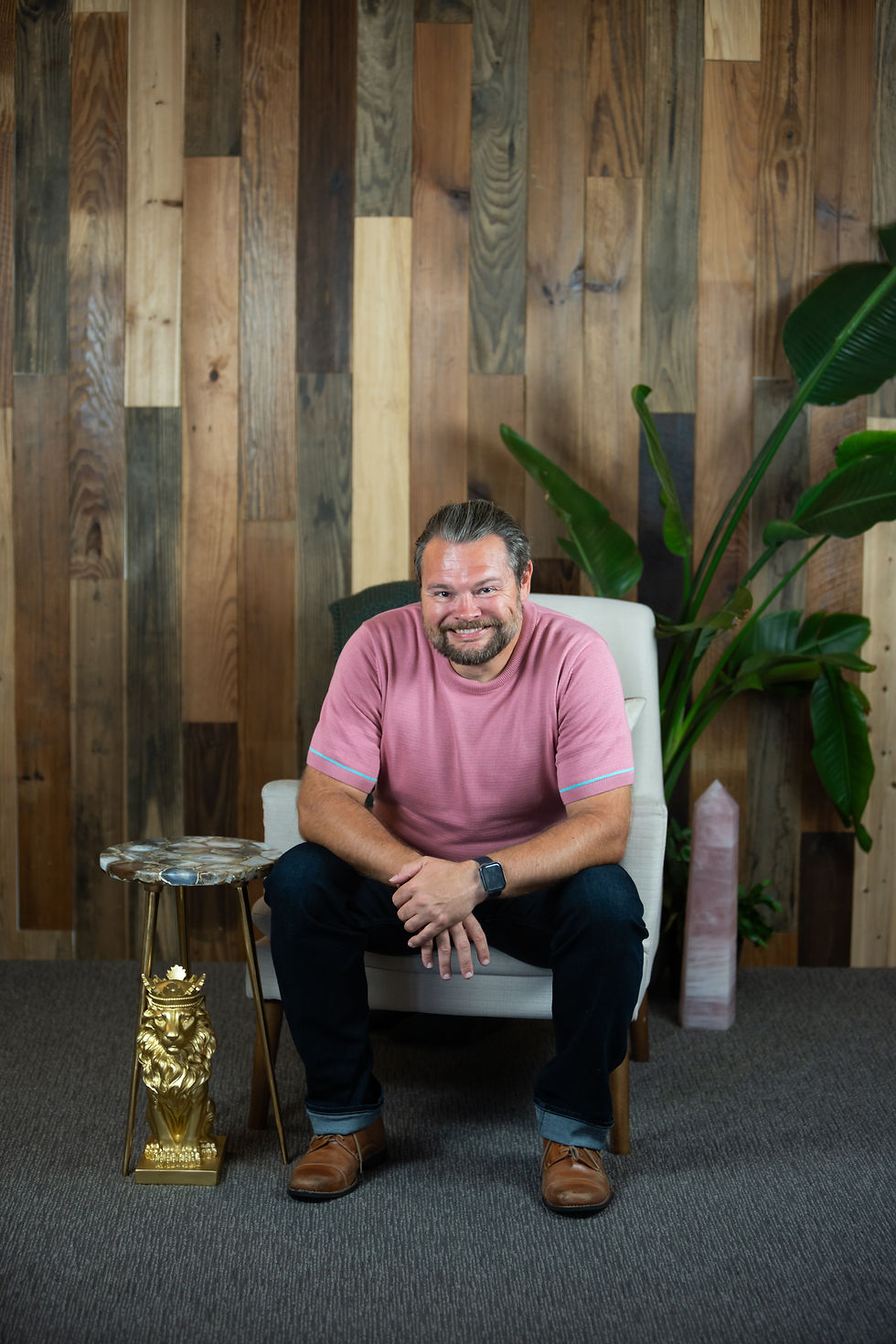 Brandon Aho sitting down with his elbows on his knees.