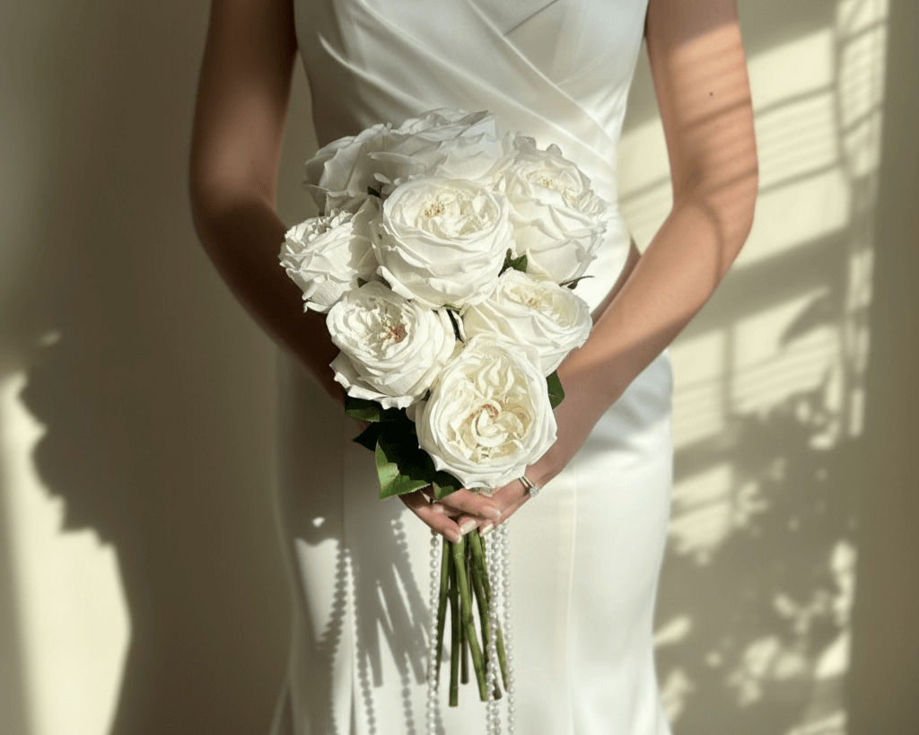Bride holding Eloven bridal peony bouquet with timeless elegance