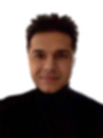 A photo of Denish Patel wearing a black jumper with a high neck.