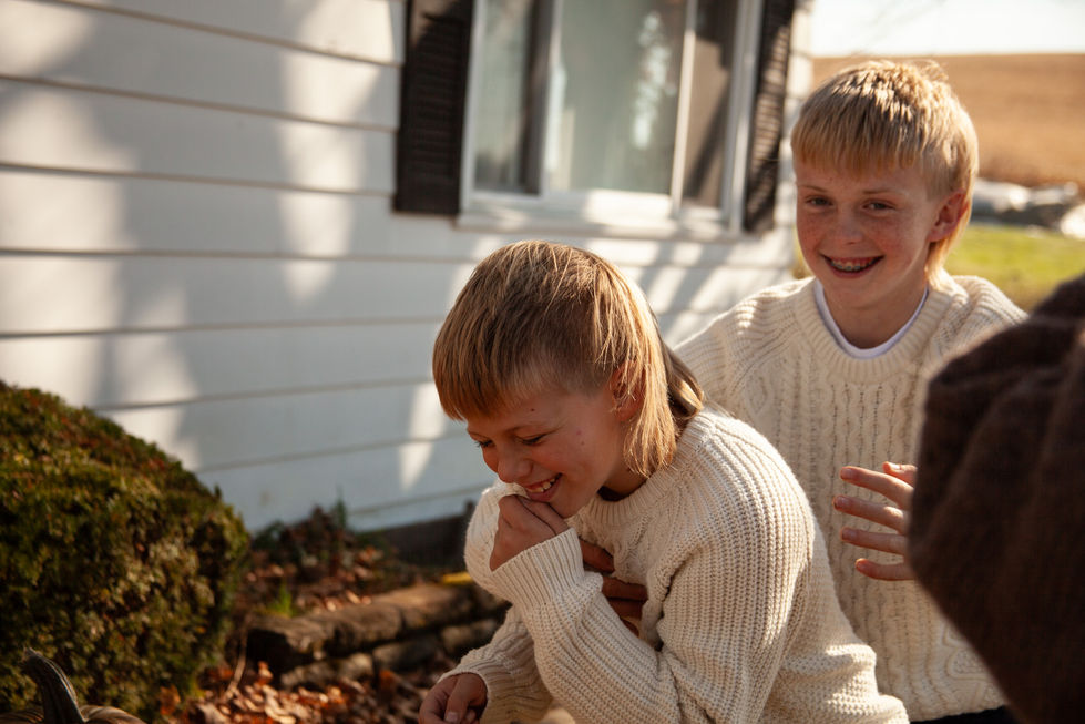 Photo of two boys joking around.