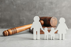 Family figure and gavel on table. Family