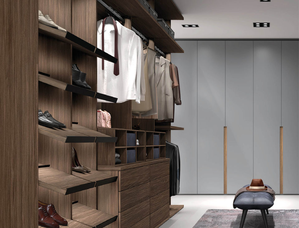 This walk-in closet features a sleek, modern design with a minimalist aesthetic. The left side has open wooden shelving for shoes and accessories, hanging space for clothes, and drawers for additional storage. The right side consists of smooth, light gray panels that conceal more storage space, creating a clean and uncluttered look.
Cherry Hill