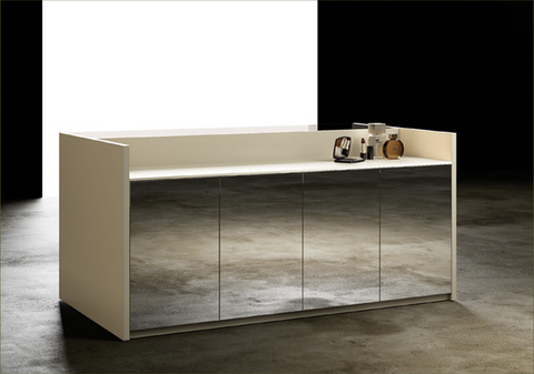 Modern cream bathroom vanity with four mirrored doors, reflecting the concrete floor, set against a split black and white background with cosmetics on the countertop. NJ