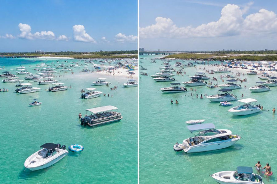 Aerial view of Crab Island sandbar during mid-morning with boats anchored in shallow emerald water, sandy beach visible, and clear blue sky overhead