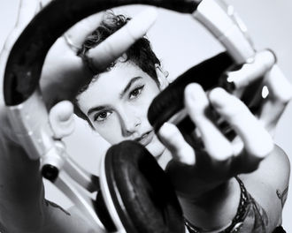 Personal branding portrait by Dan Cotton in Berkshire - perspective play as DJ looks through headphones