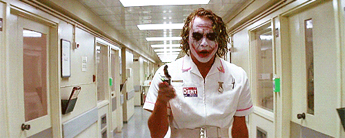a nurse dressed as the joker walks down hallway medical instrument