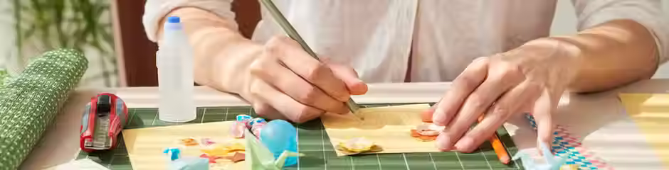 woman doing crafts and art sitting at a table