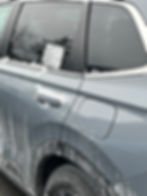 A vehicle window shows the remnants of a peeled sticker, leaving behind a stubborn, unsightly residue — worsened by snowy.