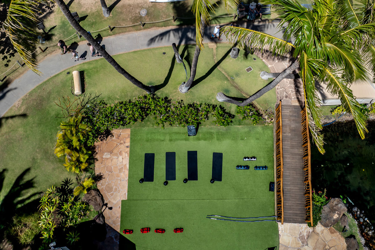 Top-down drone view of the fitness lawn with mats laid out