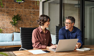 Two happy busy professional executives team business people working together on laptop com