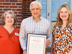 Hope Carroll and Hadley Stewart are pictured with Mayor Ron Anders, who is holding a signed proclamation.