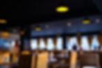 Warm and inviting restaurant ambience at Mehfil, featuring comfortable seating and modern interior design.