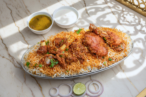 Hyderabadi Mixed Chicken Biryani in handi with salan and raita, showcasing the affordable quality of Mehfil Biryani.