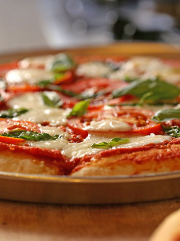 freshly made pizza on crockery for wedding hire