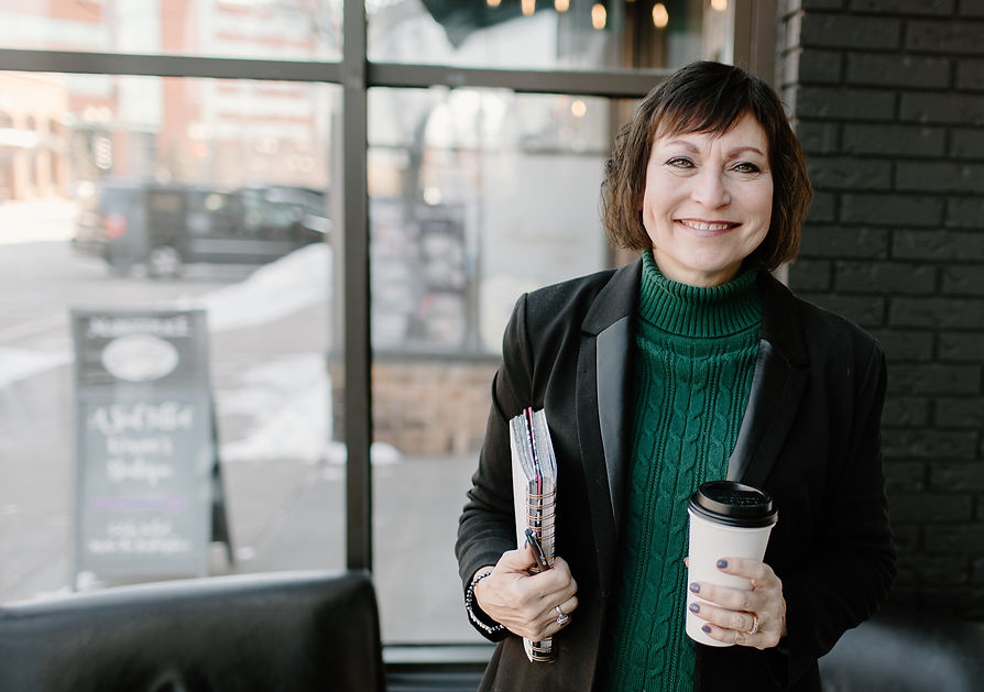 Smiling women with journal and coffee cup