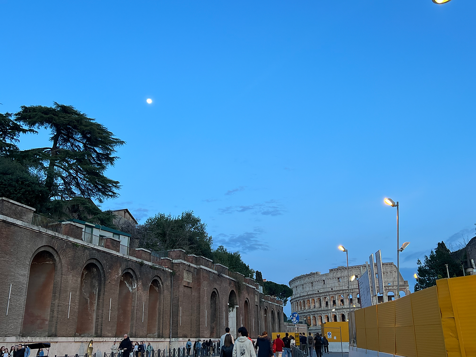 Colosseum at night beneath the moon in Rome