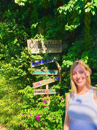 Sarah Cleveland, Career & Executive Coach standing in the forest next to a sign