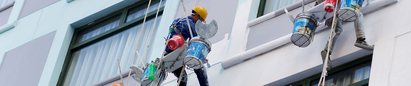 Connecticut Painters United crew working on commercial building exterior using lift equipment. Professional commercial painti