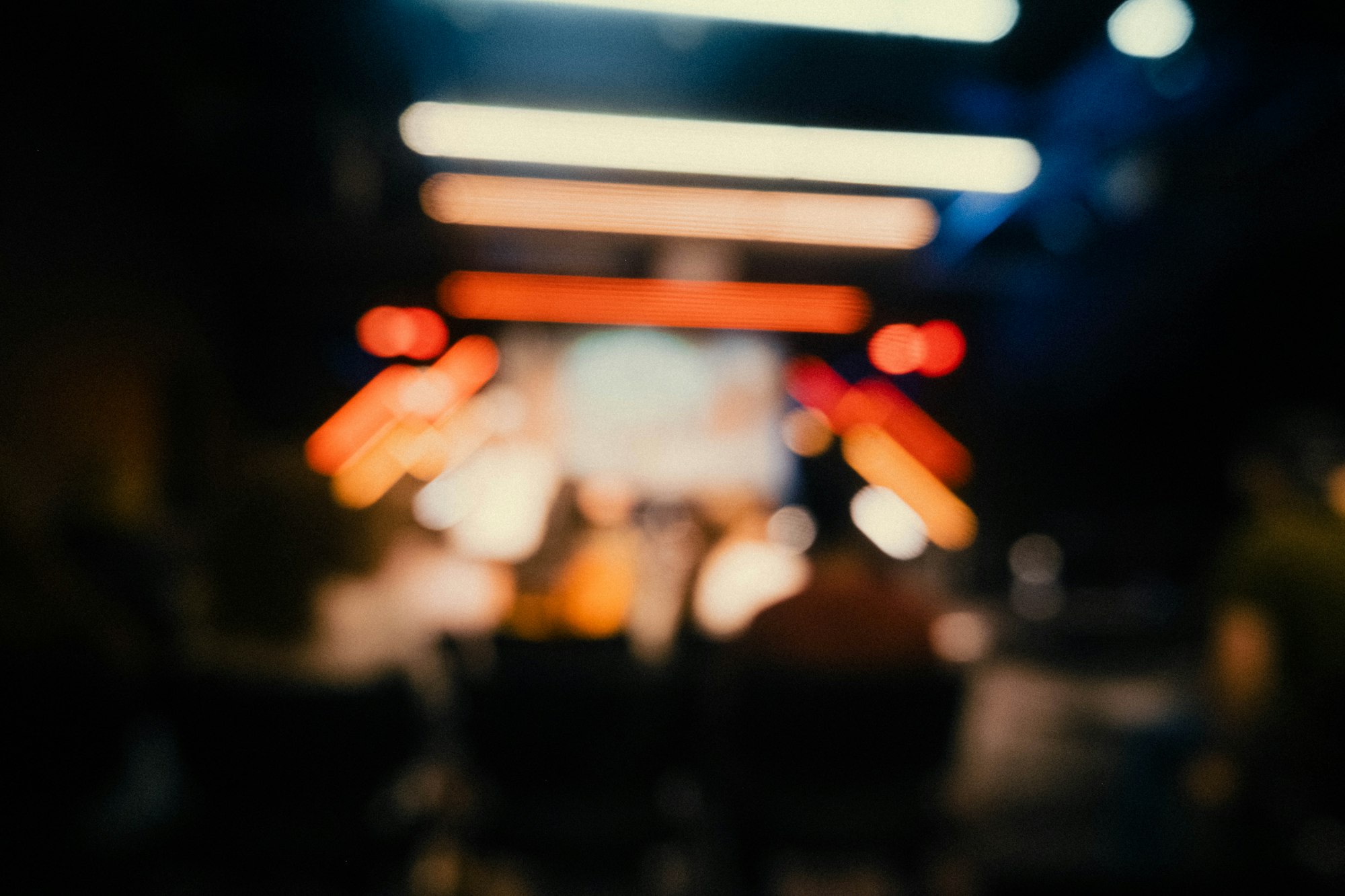 Audience silhouettes in front of bright stage lights