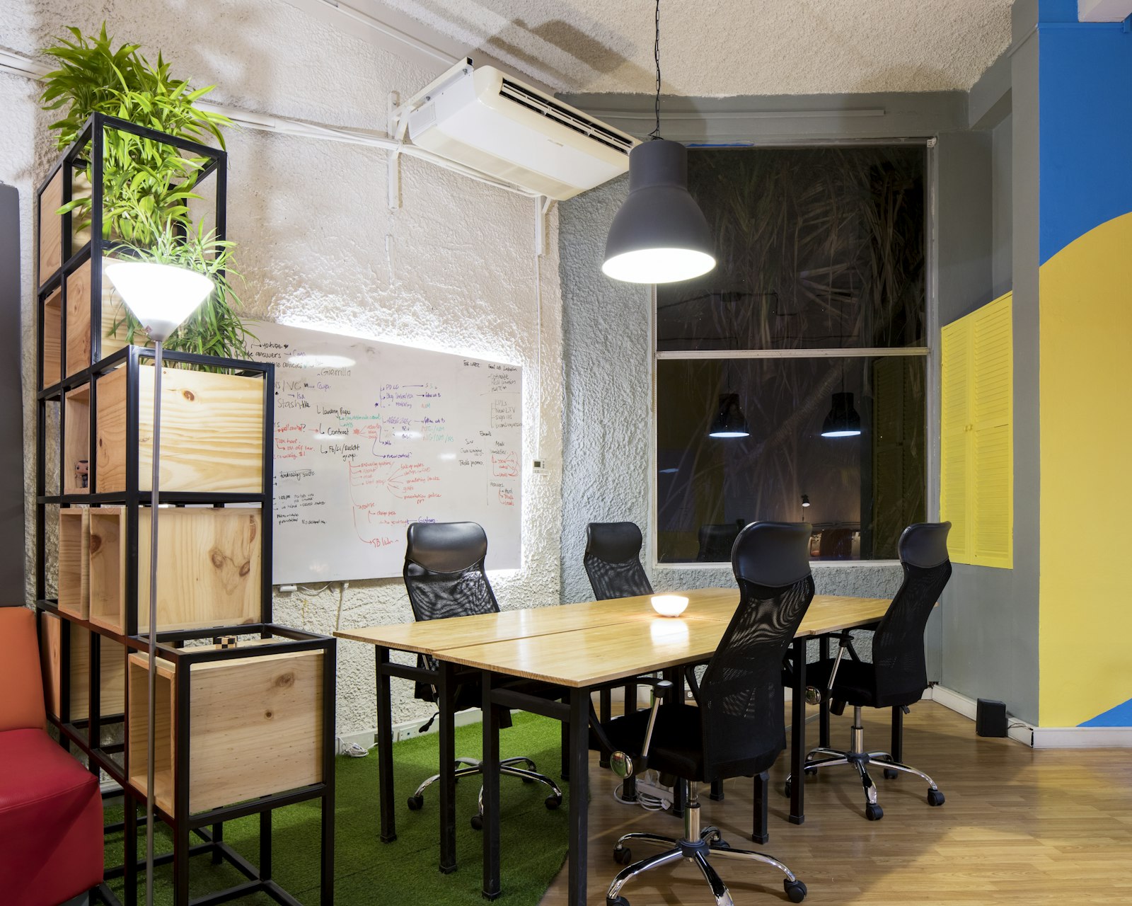 An empty meeting room with chairs and a whiteboard