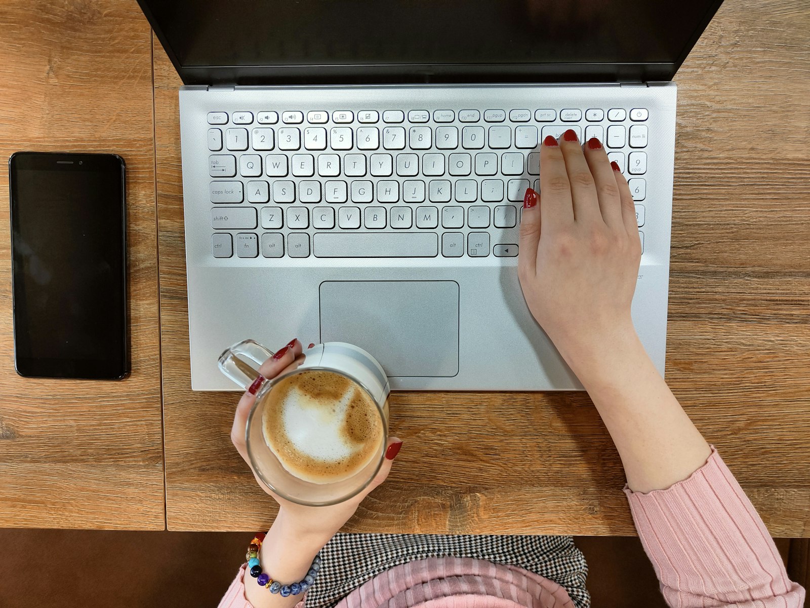 Close-up of hands typing on a laptop