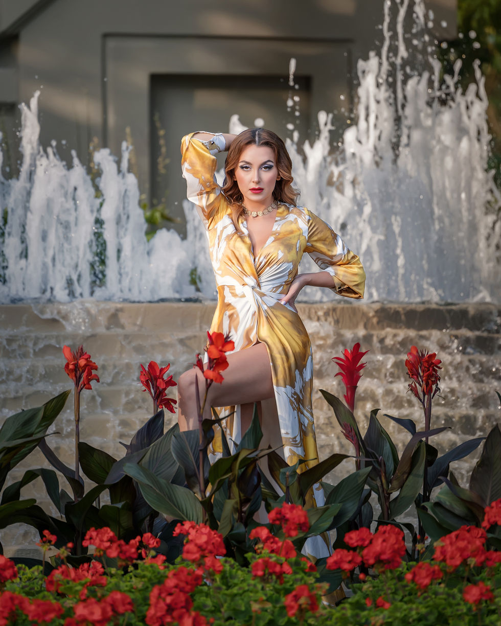 High fashion outdoor photoshoot Toronto with dramatic dress and water feature and flowers 