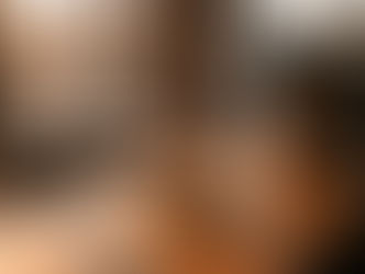 A single donut under a glass dome on an empty coffee shop counter at sunset. AI-generated image.