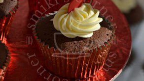 Close up of a single Chocolate Fudge Valentine cupcake topped with a mini vanilla buttercream rosette.