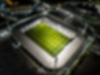 Vue aérienne d'un stade avec au centre un terrain de grands jeux