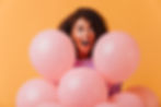 portrait-surprised-birthday-girl-looking-away-while-posing-with-balloons-funny-african-lad