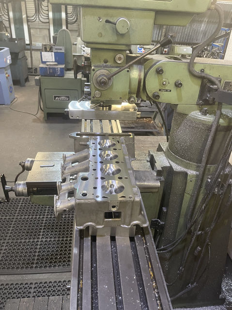 Engine cylinder head being machined on a milling machine