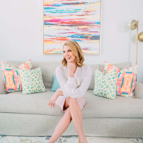 Realtor & Mom, Grace Herlong Loveless of Homes with Grace sitting on a couch