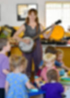 Ms. Lynne playing the banjo during a Music Adventure class