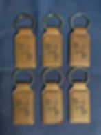 Six brown leather custom logo keychains with animal design