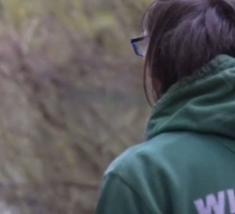 a male in a wildlife rescuer hoodie