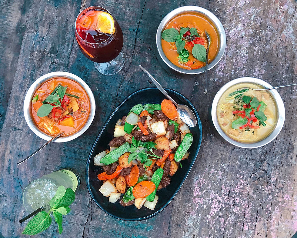 Close-up view of Thai takeaway containers with various dishes