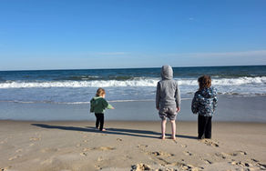three kids on a beach