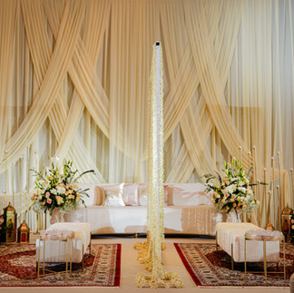 Elegant Nikaah ceremony setup featuring a floral arch and arrangements made entirely of fresh white, pink, and green blooms.