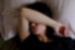 woman struggling to sleep in hotel bed