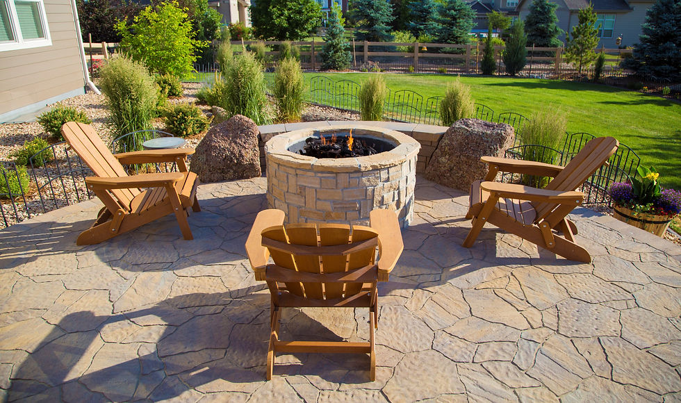 Backyard patio with fire pit and chairs around the fire pit