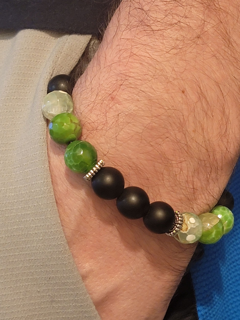 Handmade green sage beaded bracelet on a wrist